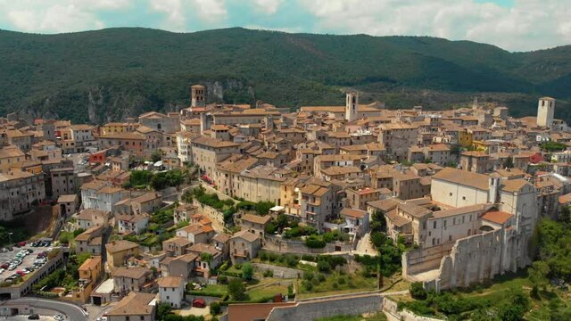 Aerial view of Narni (Terni, Umbria, Italy), medieval city with a rich history. Houses made of stone on top of the mountain. Incredible views. Summer day. Europe travel and vacation concept