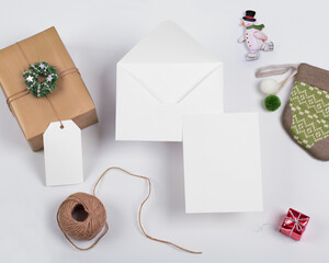 Beautiful Blank White Christmas Greeting Card and open envelope beside gift box