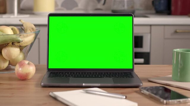 Laptop on Wooden Table in Kitchen Interior