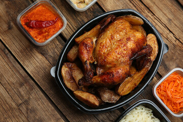 Plastic containers with different dishes on wooden table, flat lay. Food delivery service
