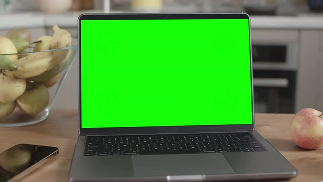 Laptop on Wooden Table in Kitchen Interior