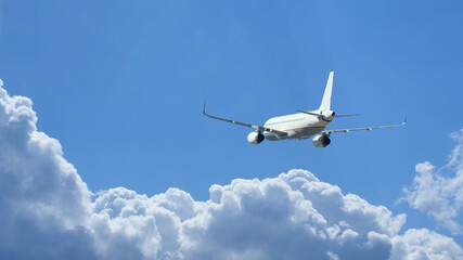 Fototapeta na wymiar Ultra wide zoom photo of passenger airplane taking off in deep blue sky and beautiful clouds