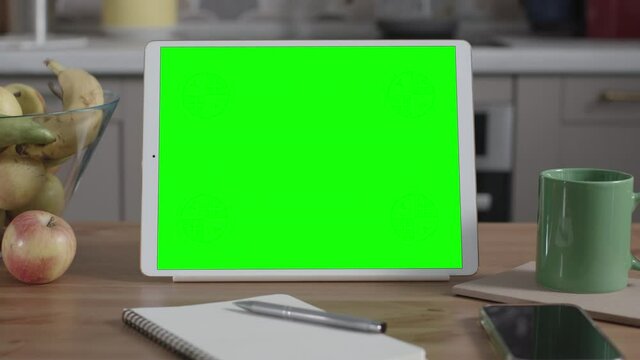 Tablet on Wooden Table in Kitchen Interior