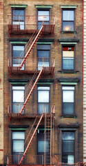 Old townhouse building with iron fire escape, New York City, USA.