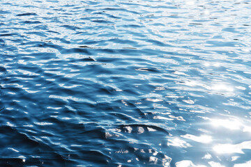 Ripples on lake water. Sunlight reflecting in water. Sun shining by the lake. Ocean wave background. Wavy pond texture. Messy water flow. Blue water surface background. Sky reflection pattern.