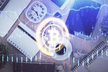 Double exposure of blockchain theme hologram over table with phone. Top view. Crypto technology...