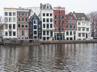 Fototapeta na wymiar Amsterdam canal houses and their reflections in the water