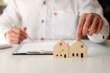 Buying a Home or Insurance, an insurance agent explains the lease agreement to a client before making a contract. Mortgage loan approval home loan and insurance concept.