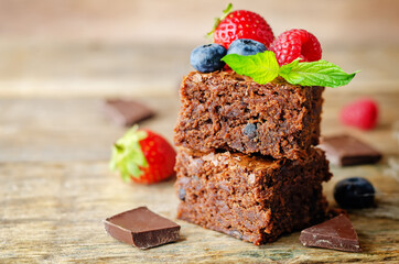 Chocolate brownie with berries and mint leaves