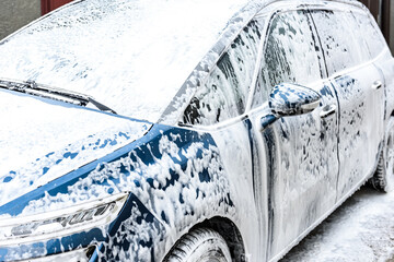 High pressure automobile cleaning with foam in car wash.