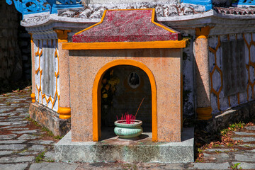 Incense sticks and flowers in the ancestral altar in Vietnam.