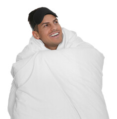 Man in sleeping mask wrapped with blanket on white background