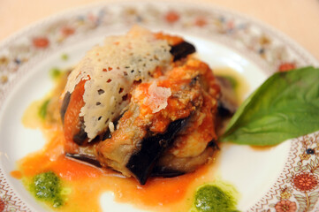 Parmigiana is a typical food from Italy with aubergine mozzarella parmigiano cheese tomato sauce