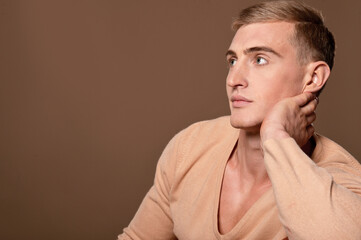 Fototapeta premium Portrait of thoughtful handsome young man posing in studio