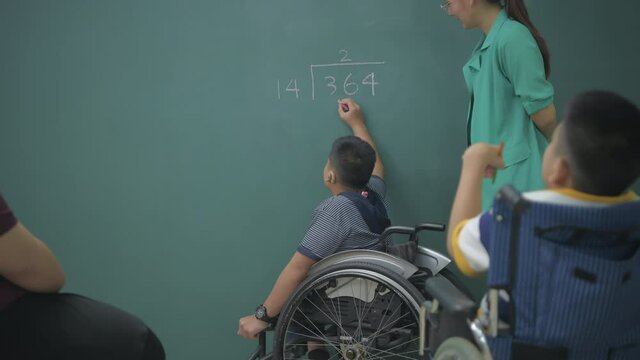 Education concept of 4k Resolution. Asian boy solves math problems on blackboard.