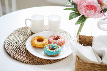 breakfast bright donuts with milk in a light kitchen on a white plate. food concept.
delicious lunch