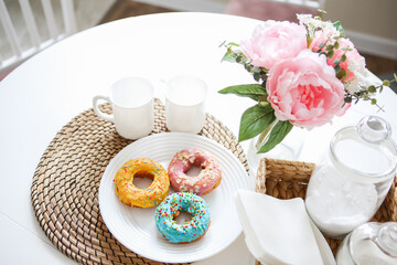 breakfast bright donuts with milk in a light kitchen on a white plate. food concept.
delicious lunch