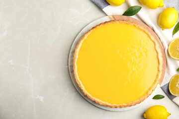 Delicious homemade lemon pie and fresh fruits on light table, flat lay. Space for text