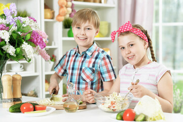 Cute brother and sister cooking   together in kitchen