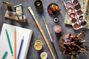 Paintbrush and tubes with painter tools at abstract table background texture. Art painter concept