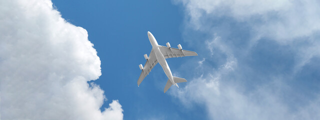 Ultra wide photo of passenger commercial airplane flying above head as shot from the ground in deep blue cloudy sky