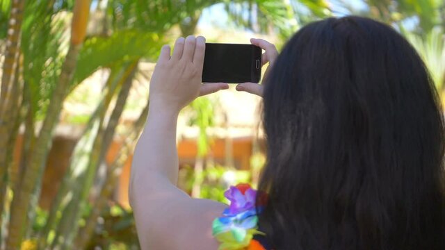 Woman taking picture in Hawaii in slow motion 180fps