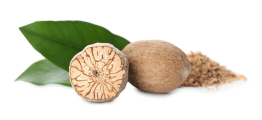 Grated nutmeg and seeds with green leaves on white background