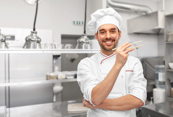 happy smiling male chef with chopsticks