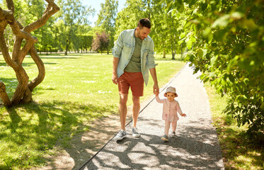 happy father with baby daughter walking at park