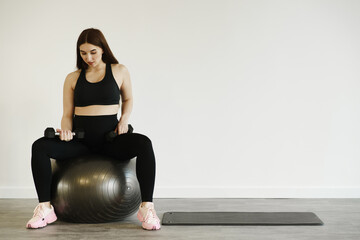 Fototapeta premium Pregnant woman playing sports on fitball