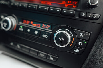 Car climate control panel with air conditioning on. The air conditioning system is ready for high summer temperatures