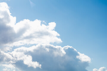 Blue sky with white clouds and skylights on a bright sunny day, soft focus