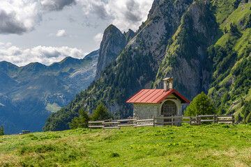 Fototapeta na wymiar Alpine huts, meadows, lakes and woods of the Friulian mountains