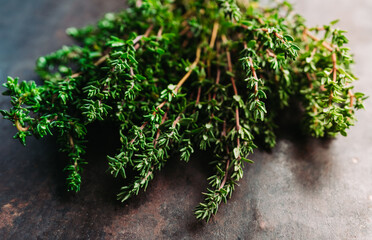 Freshly harvested bunch of thyme on the rustic background. Selective focus. Shallow depth of field.