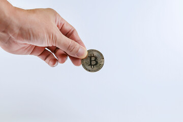 Fototapeta na wymiar Cropped hand holding bitcoin isolated on the white background 