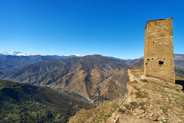 Fototapeta na wymiar Ancient guard tower on the edge of a rock at Goor village in Dagestan