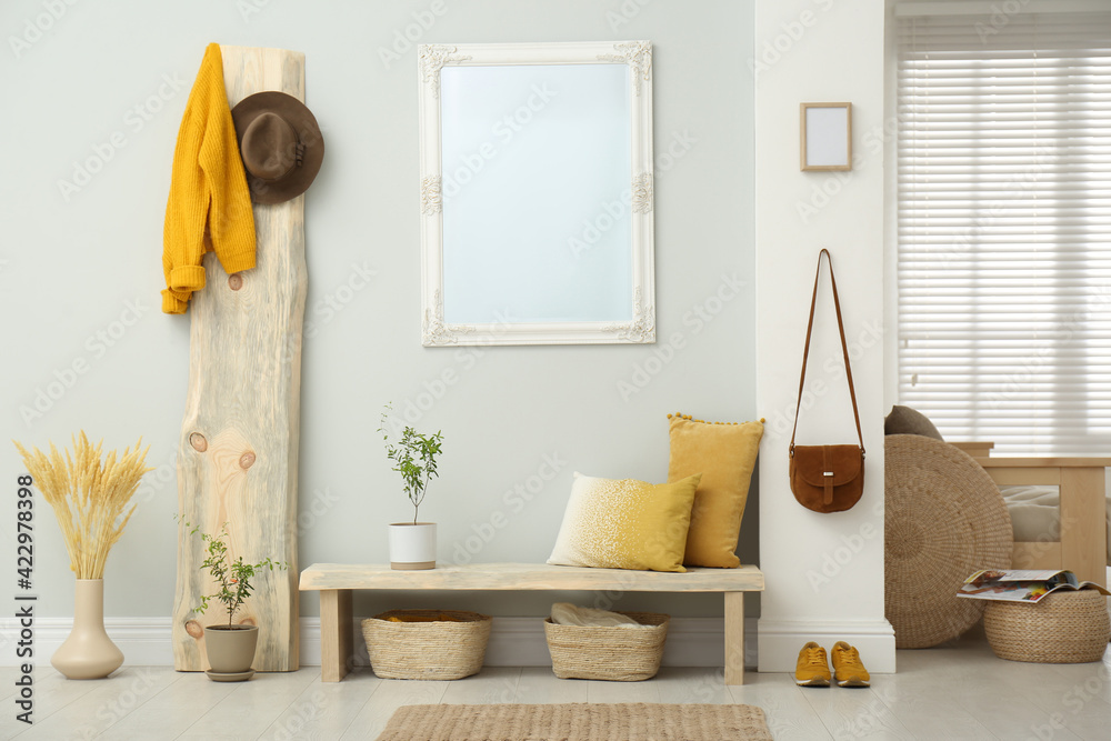 Poster Hallway interior with wooden bench, clothes and mirror