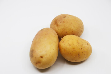 Three raw potatoes in white background