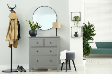 Fototapeta premium Hallway interior with stylish furniture, clothes rack and mirror