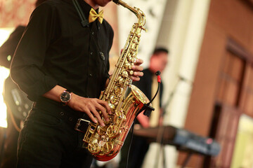 Yogyakarta, Indonesia, Jan 12, 2018.The saxophone player plays his instrument at a wedding party.