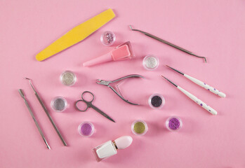Manicure accessories on an isolated pink background.