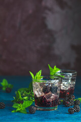 Cold summer berry drink with blackberries. Refreshing summer drink with syrup, blackberry and ice...