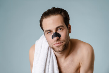 Close up of a brunette shirtless man with stubble