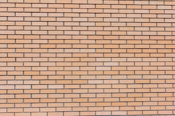 Brick background.A fragment of a new orange brick wall.