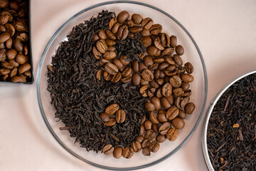 Coffee beans and black tea leaves, laid out in the yin-yang symbol