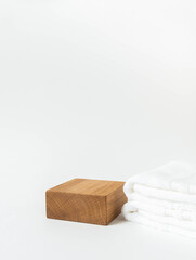 Empty wood cube podium for products presentation. Display stand and white towel