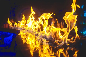 Flame fire on bar counter nightclub background