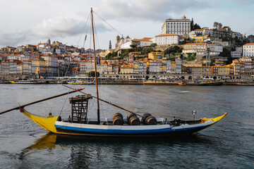 Typical boat in Porto, Portugal old town skyline from across the Douro River.