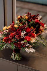 red elegant wedding bouquet of fresh natural flowers
