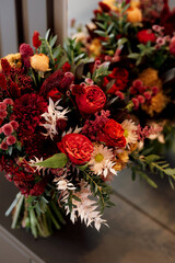 red elegant wedding bouquet of fresh natural flowers